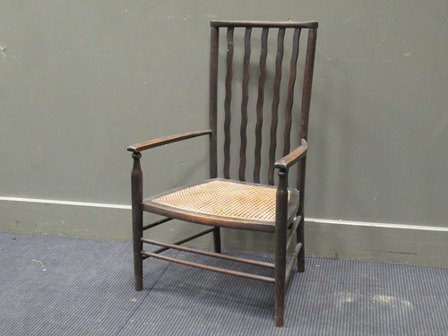 Lot 384 - A 20th century wavy stick back elbow chair...
