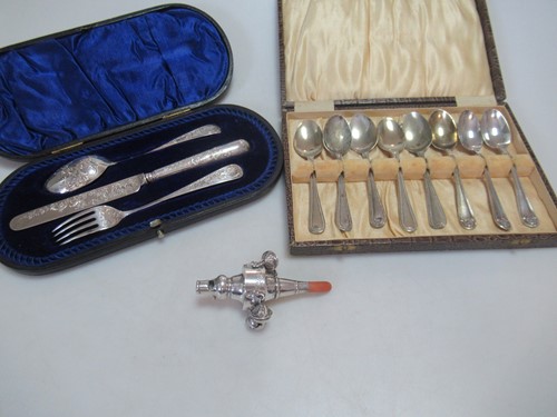 Lot 186 - A silver rattle with coral teether, together...