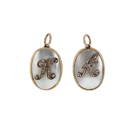 Lot 151 - Two Edwardian mother of pearl and diamond set initial pendants