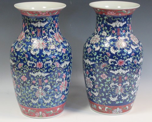 Lot 10 - A pair of large famille rose vases decorated...