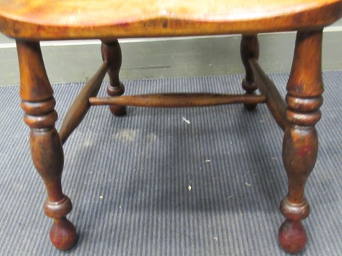 Lot 335 - A Windsor armchair on turned legs united by a...