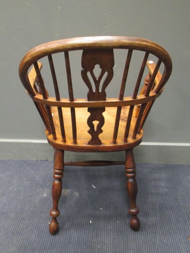 Lot 335 - A Windsor armchair on turned legs united by a...