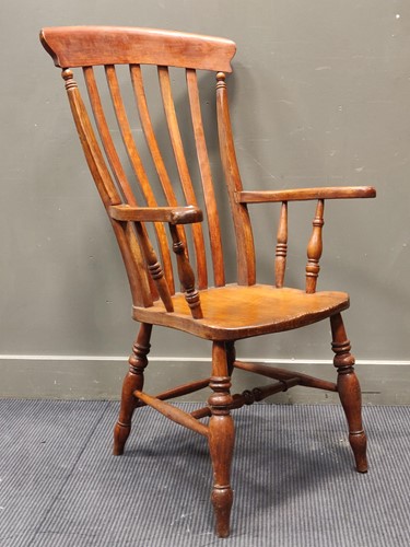 Lot 353 - A Windsor style comb-back armchair on turned legs