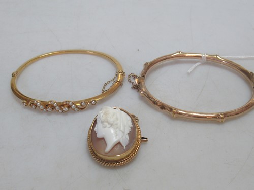 Lot 174 - A pearl and diamond bangle, tested as 9ct gold,...