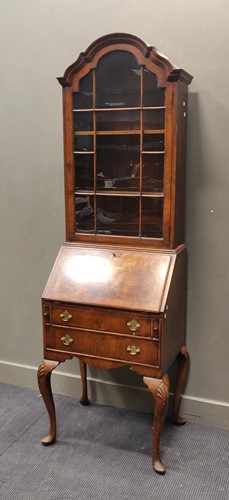 Lot 327 - A Queen Anne revival dome top walnut bureau...