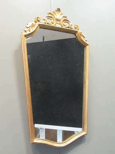 Lot 344 - A carved giltwood wall mirror surmounted by a...