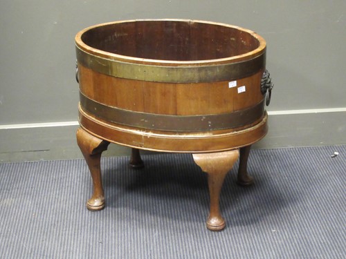 Lot 348 - A Georgian style mahogany and brass bound oval...