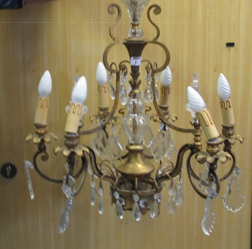 Lot 87 - A gilt and glass chandelier with foliate stems;...