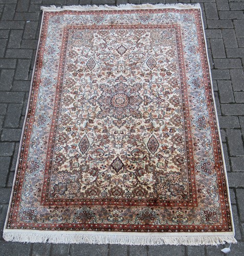 Lot 412 - A modern finely-woven Kashan silk rug, 192 x...