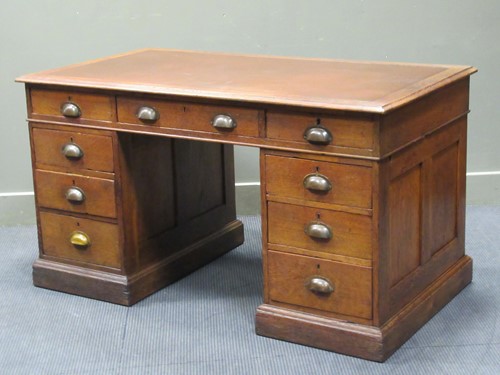 Lot 347 - A panelled oak twin pedestal desk of nine...