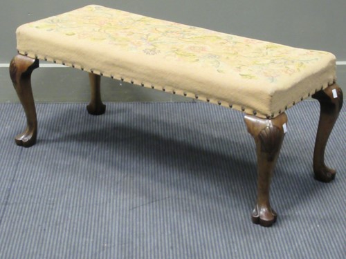Lot 342 - A walnut needlepoint long stool on carved...