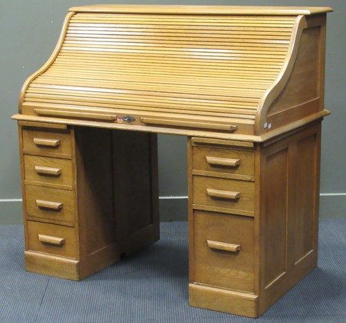 Lot 270 - A 20th century blonde oak roll top desk, 143 x...