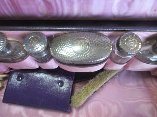 Lot 240 - A purple leather and silk linked travelling...