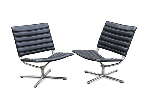 Lot 287 - A pair of Danish black leather and chrome swivel easy chairs