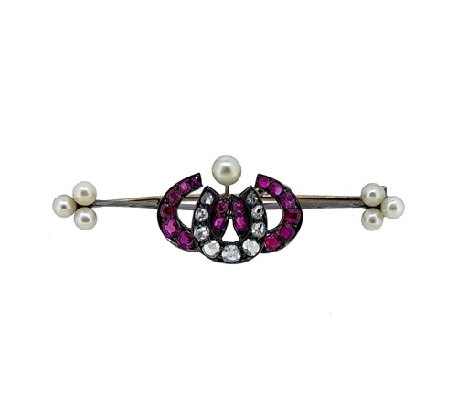 Lot 159 - A Victorian ruby and diamond triple horseshoe brooch