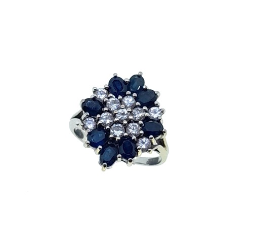Lot 213 - A late 20th century sapphire and diamond cluster ring