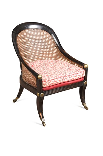 Lot 471 - A Regency brass and ebonised bergere armchair