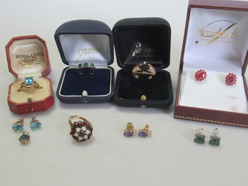 Lot 216 - Two hallmarked 9ct gold garnet rings, a topaz...