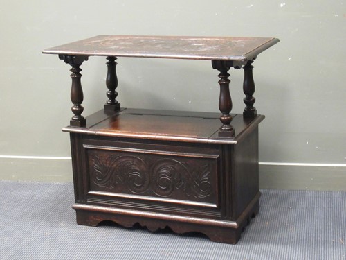Lot 493 - A 19th century oak monks bench, the table top...
