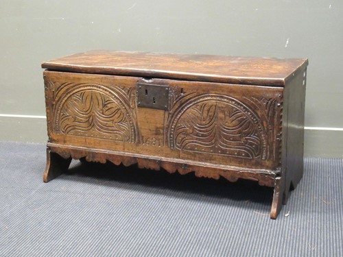 Lot 494 - A carved oak six plank chest bearing the date...