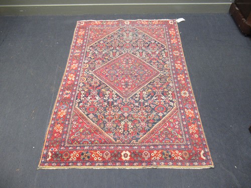 Lot 569 - A blue ground rug with central medallion, 202...