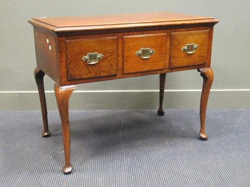 Lot 398 - An 18th century style oak three drawer side...