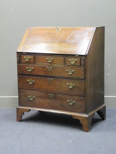 Lot 491 - A George III oak bureau, the fall front...