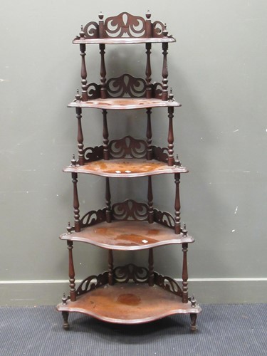 Lot 406 - A Victorian walnut corner what-not with carved...
