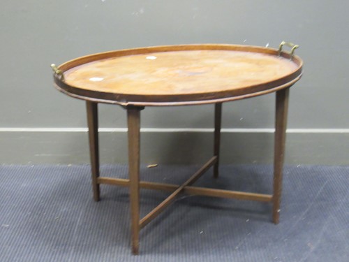 Lot 400 - A mahogany oval tray top occasional table, 50...