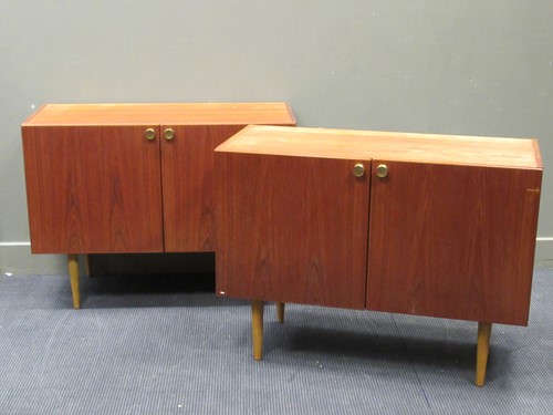 Lot 533 - A pair of Danish late 20th century two door side cabinets with metal handles and tapered legs (2)