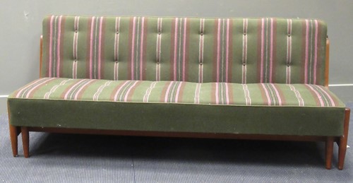 Lot 565 - A late 20th century Danish teak day bed with a green and pink buttoned upholstery