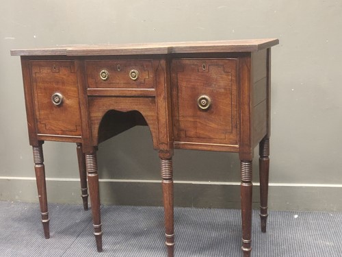 Lot 448 - A small Regency mahogany breakfront sideboard...