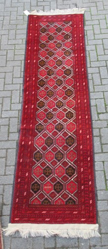 Lot 575 - A red ground runner together with a red ground rug with three medallions (2)