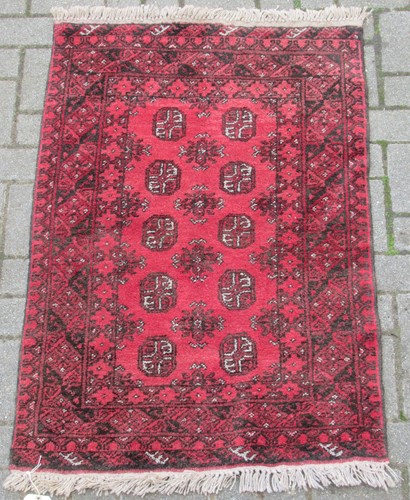 Lot 580 - A Tekke rug, together with a Tekke type rug and a purple ground rug (3)