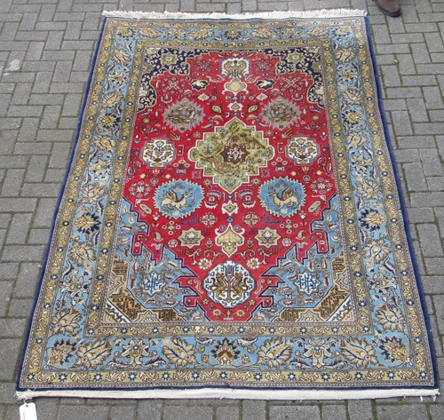 Lot 582 - A modern Persian style rug decorated with mythical creatures and another with blue ground (2)
