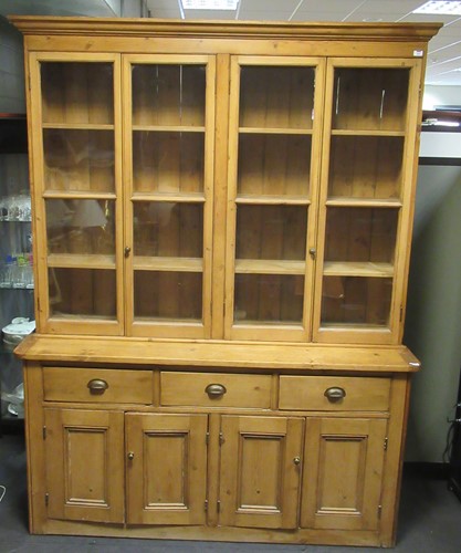 Lot 465 - A large pine dresser with a glazed top section...