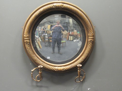 Lot 468 - A regency gilt wood convex wall mirror with...