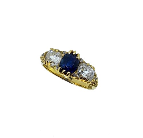 Lot 218 - A sapphire and diamond carved half hoop ring