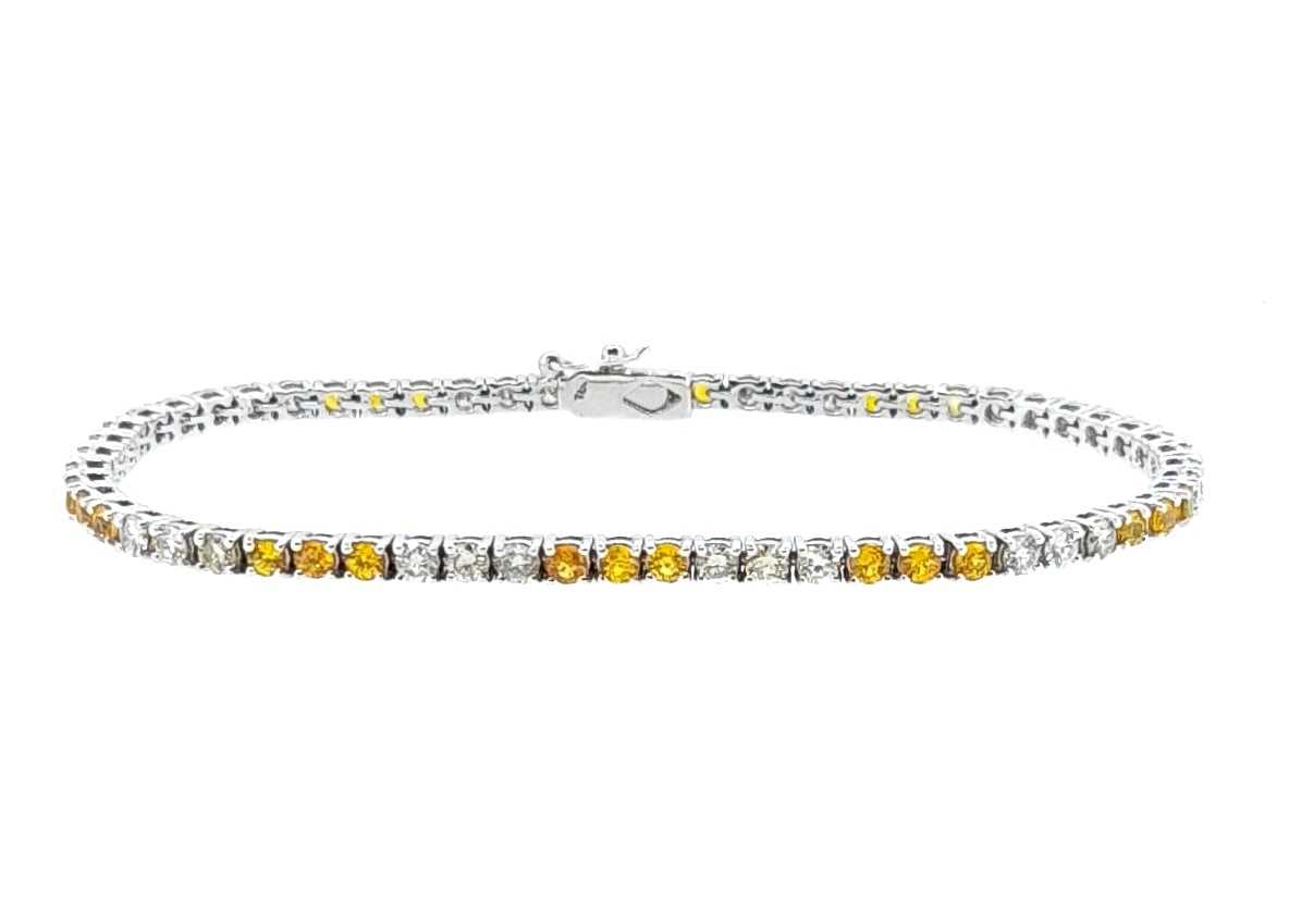 Lot 204 - A yellow sapphire and diamond line bracelet