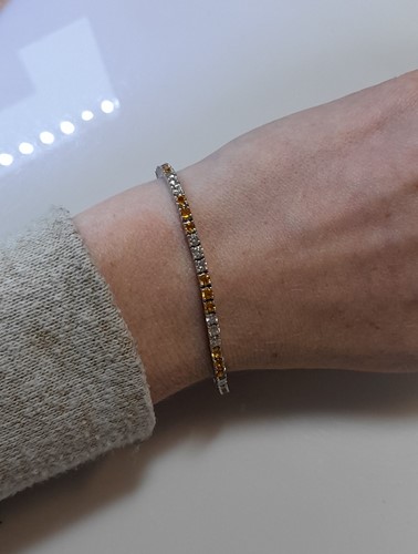Lot 204 - A yellow sapphire and diamond line bracelet
