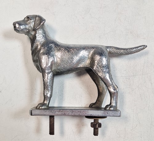 Lot 212 - A white metal car mascot in the form of a dog