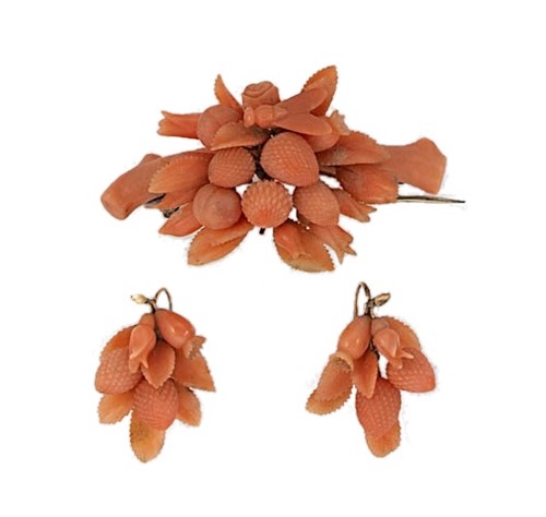 Lot 29 - A carved coral brooch with matching ear pendants