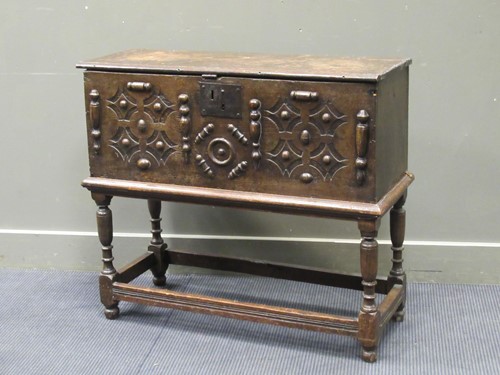 Lot 453 - An 18th century oak plank chest on stand, with...