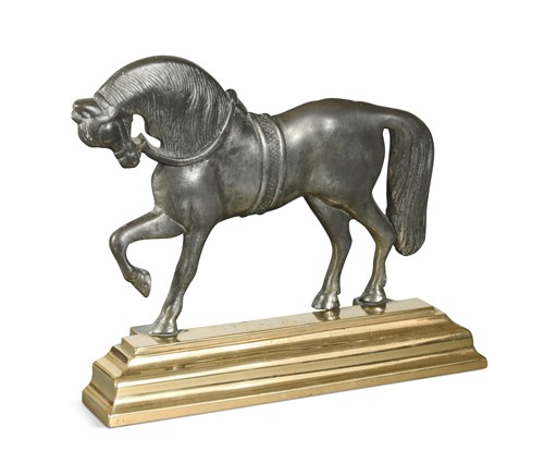 Lot 300 - A polished pewter and brass doorstop, 19th century