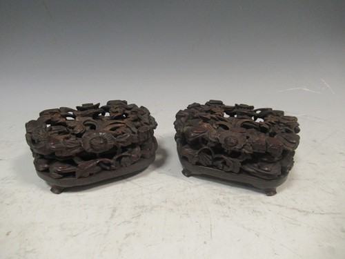 Lot 10 - A pair of Chinese carved wood stand with...