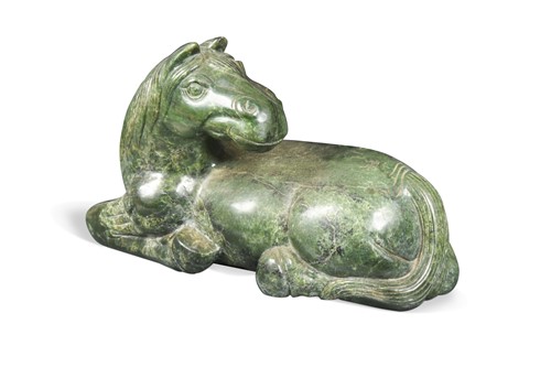 Lot 70 - A Chinese spinach jade type recumbent horse, Ming style, 20th century