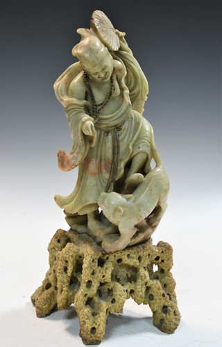 Lot 71 - A Chinese soapstone figure of a deity with a lion, early 20th century