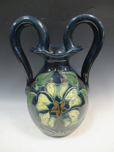 Lot 78 - A large Majolica twin handled water carrier,...