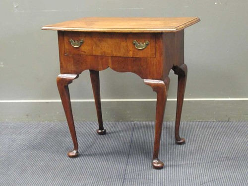 Lot 519 - An 18th century style walnut veneered lowboy...