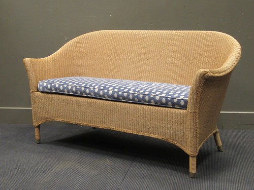Lot 575 - A Lloyd Loom sofa, with loose spotted cushion...
